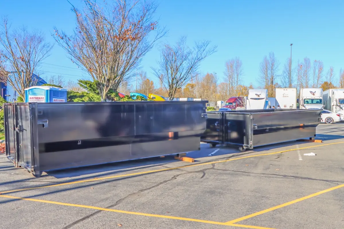Professional dumpster rental service with roll-off container on residential driveway in Los Angeles